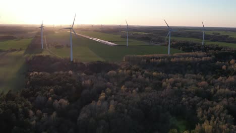 wind turbine farm at sunset, green energy, future electricity, aerial footage.