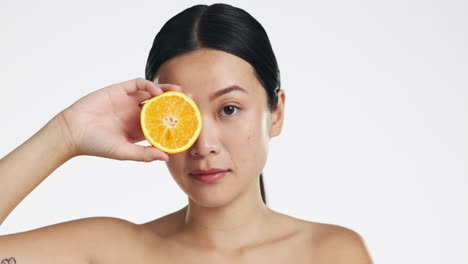 Orange-fruit,-skincare-and-face-of-woman