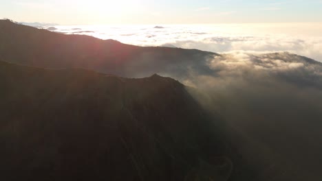 aerial sunrise view over clouds on ligurian mountain, italy, warm tones