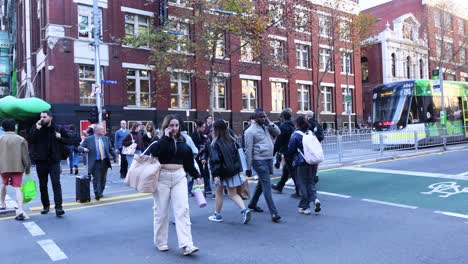 pedestrians crossing road in melbourne, australia