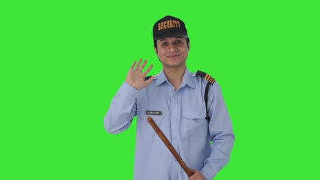 Happy-Indian-security-guard-waving-Hi-to-the-camera-Green-screen