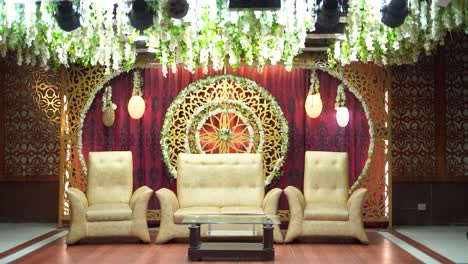 an amazing shot of the gorgeous stage set up at a traditional asian wedding with stunning red and golden décor