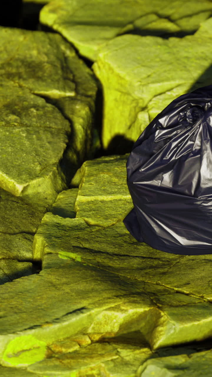 Garbage bag placed on rocks near water in early morning light