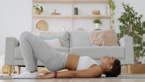 woman doing a bridge pose at home