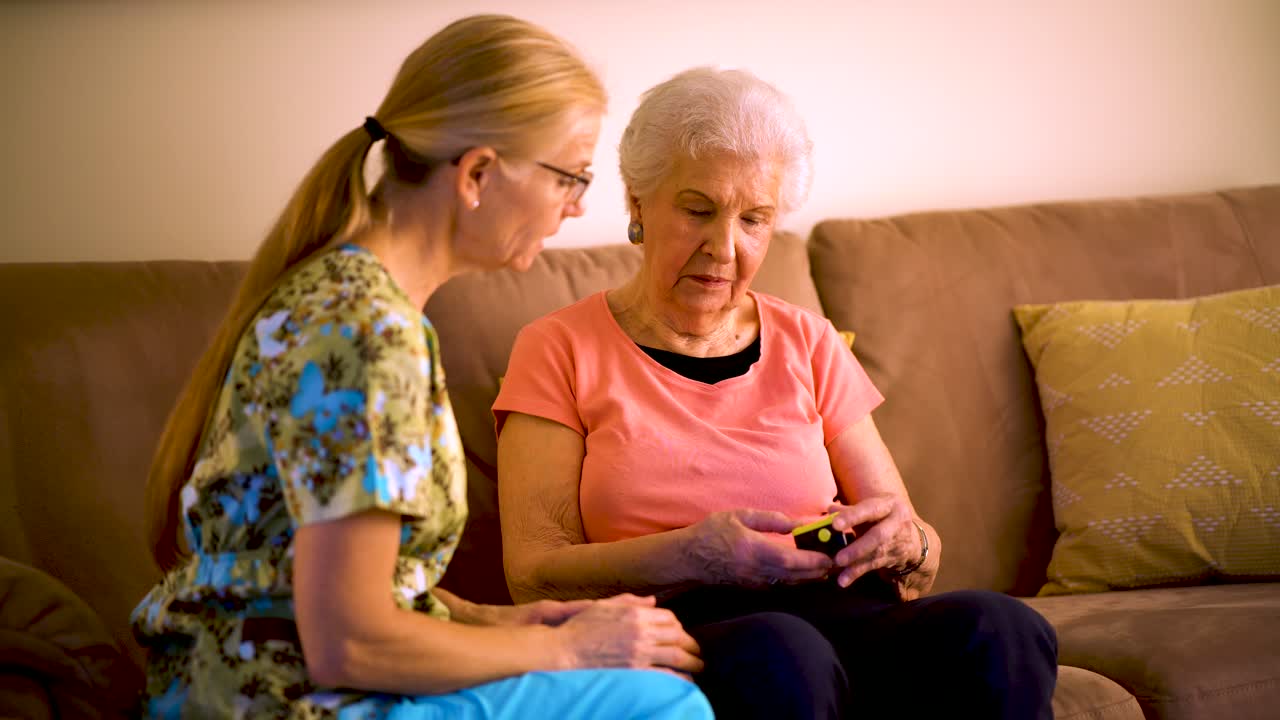 Measurement of the pulse on elderly woman. Placed on the finger heart rate monitor