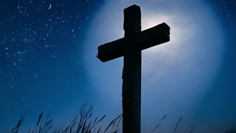 wooden cross stands silhouetted against a night sky as a bright moon rises slowly behind it, creating a serene scene