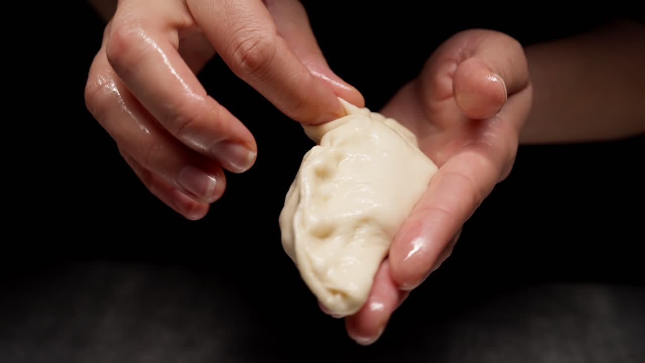 Close-up of Hands Shaping Dough for a Dumpling