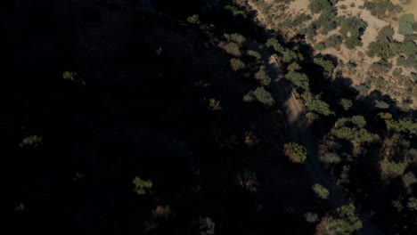 aerial panning up to desert valley landscape with mountain in distance, 4k