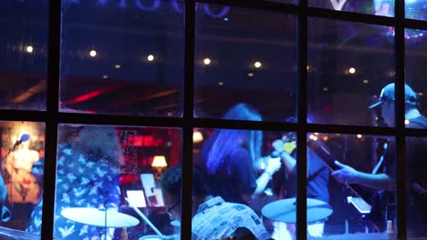 musicians performing in a vibrant, colorful bar