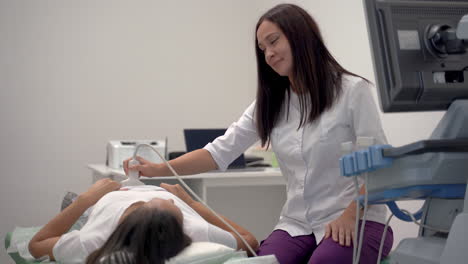 Female-Doctor-Doing-Ultrasound-To-A-Patient-Lying-On-Hospital-Gurney