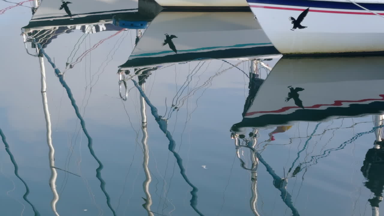 Moored sailing yacht reflections in the still water at Poole Harbour on the south coast of England,