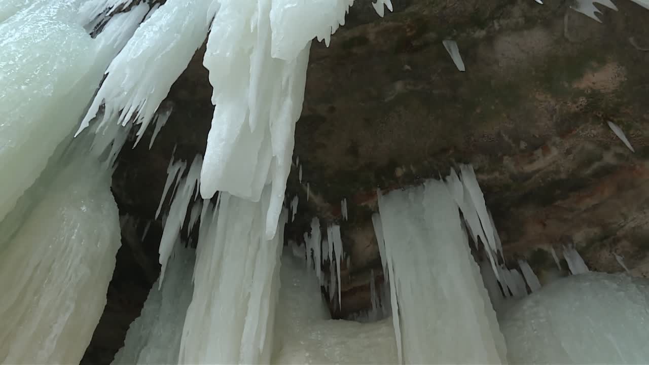 Water Dripping On The Ceiling Of Eben Ice Caves With Stalactites In Michigan, USA. - low angle shot