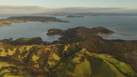 peaceful and quaint coastline landscape of waiheke island, new zealand. cloudy sunset time with idyllic scenery and ocean water along coastline. aerial wide shot