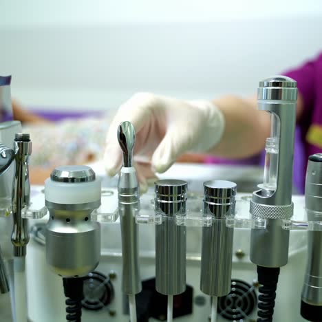 ultrasonic scrabbing. ultrasound cavitation facial peeling. cosmetology facial skin care treatment cleaning. beautician hands at work