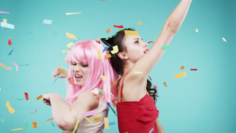 girlfriends dancing wearing red dress and pink hair in slow motion party photo booth