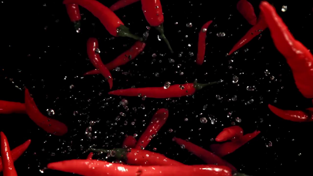 Fresh Red Chili Peppers Falling with Water Splashes