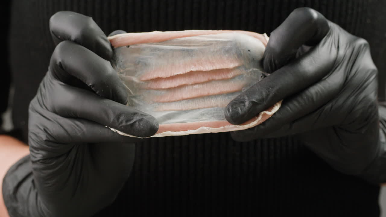 A rubber fake finger with blood close-up. Make-up equipment props for films and shooting. Bloody fake fingers for halloween and parties