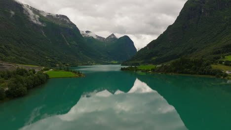 Scenic-Oldevatnet-glacier-lake-surrounded-by-imposing-mountains,-Norway