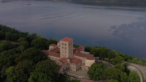 downward facing counterclockwise aerial orbit of the cloisters on the bank of the hudson river in upper manhattan nyc