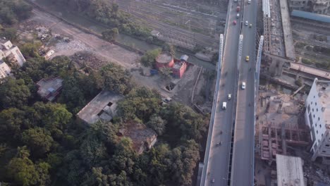 aerial drone shot flying over majerhat cable bridge road close to construction site of majerhat metro station, kolkata