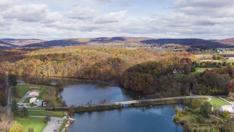 aerial hyperlapse, timelapse of speedwell forge lake in lititz, lancaster county pa, usa during autumn