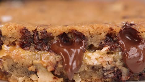 Macro-close-up-of-gooey-blondie-brownie-with-melted-chocolate-4k-pan-left-caramel-and-coconut