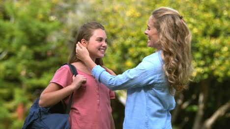 mother arranging her daughters hairs