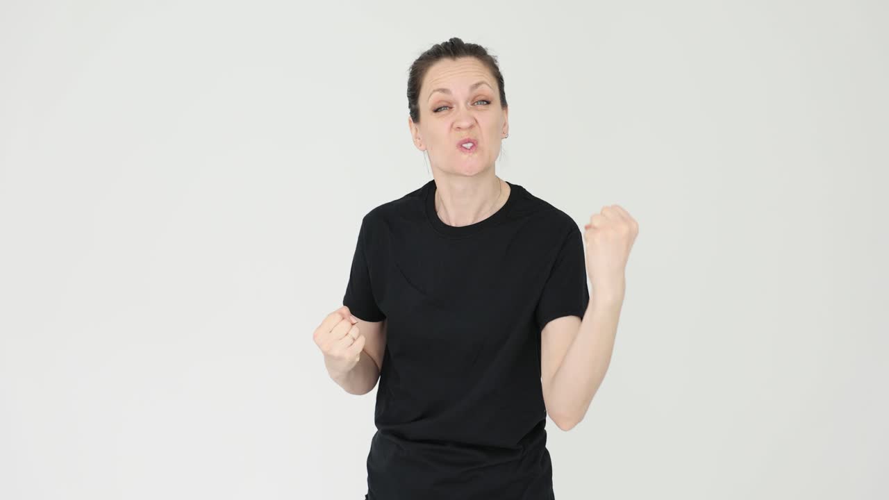 Woman showing angry and defiant expressions with clenched fists