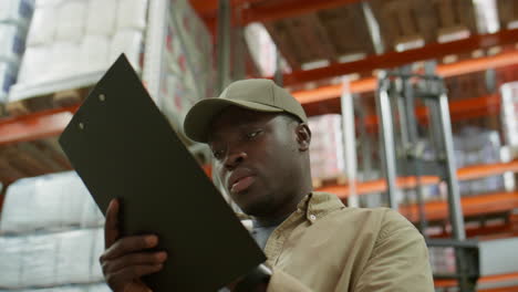 warehouse worker checking inventory with clipboard
