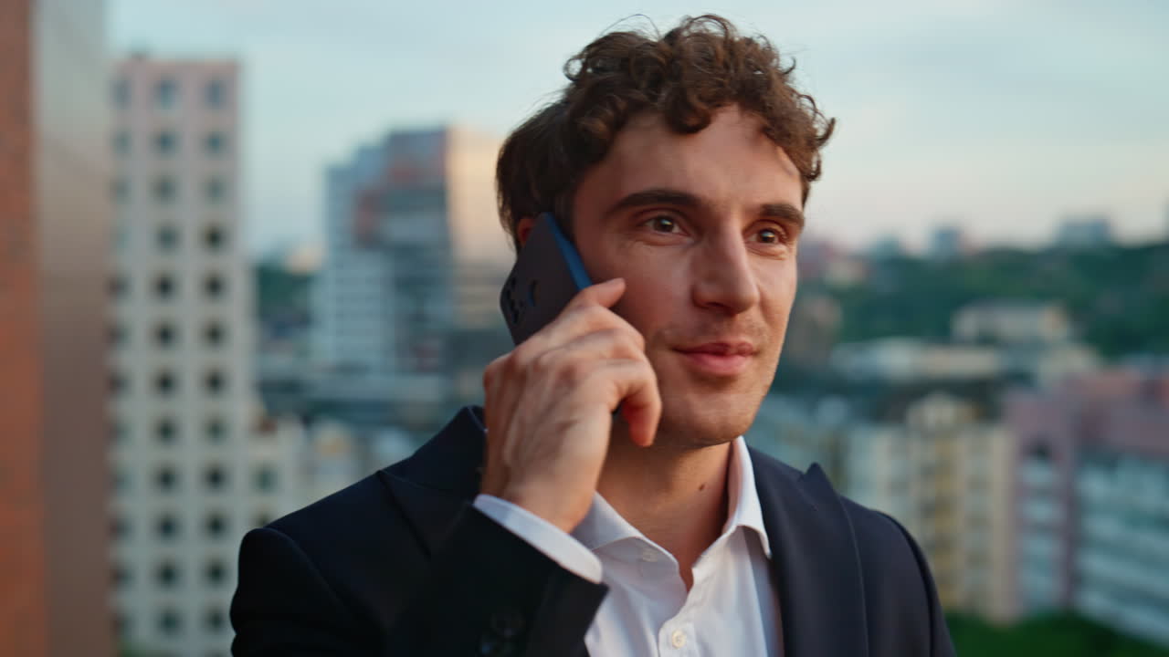 Confident business owner calling cellphone standing skyscraper terrace closeup