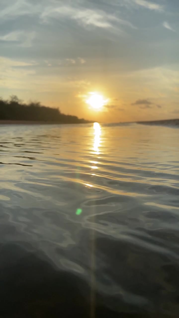 Serene Golden Sunset Reflected on Calm Ocean Water