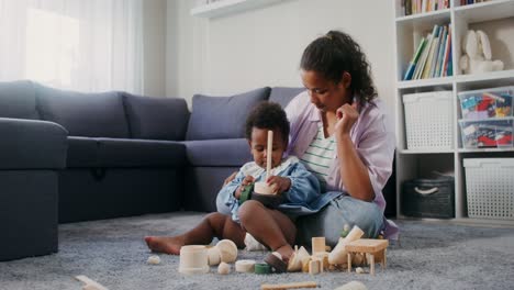 mother and baby playing with wooden toys