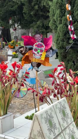 day of the dead cemetery with decorative offerings in vertical shot