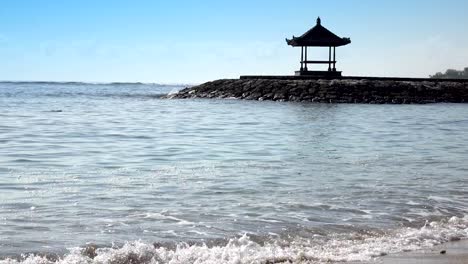 traditional national arbor against the background of the blue sky on the bank of the tropical beach in sunny day. bali. indonesia