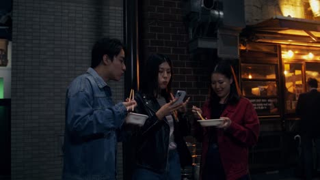 friends enjoying street food at night