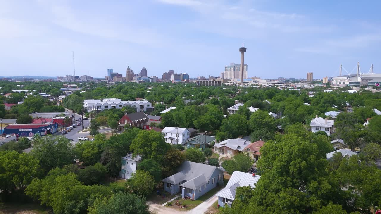 Landscape drone shot of the city of San Antonio downtown that includes the famous Alamodome, the Hemisfair Tower of Americas and the city's skyline from the South side of town.