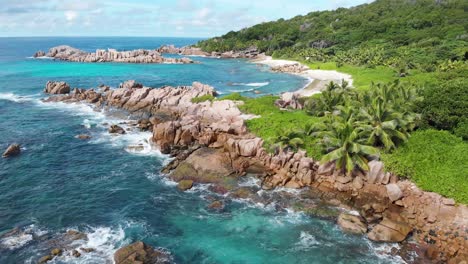 aerial view of waves breaking at the unpeopled coastline at anse songe on la digue, an island of the seychelles