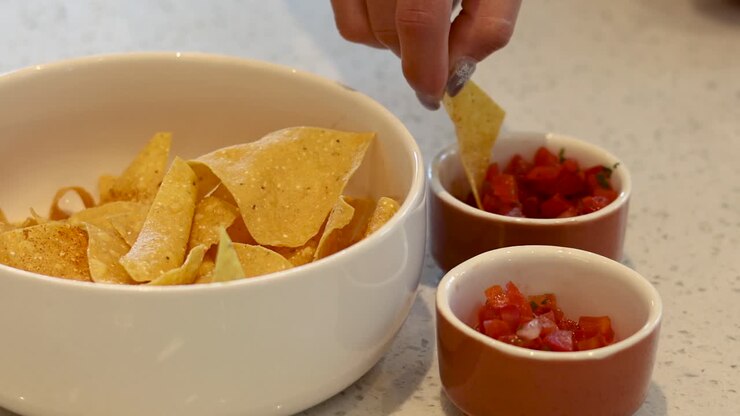 Sequential dipping of nachos into salsa sauce