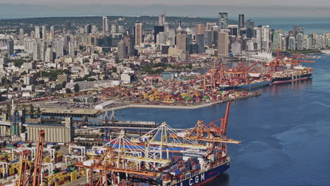 vancouver bc canada aerial v92 drone flyover the harbour capturing bustling container terminal, a crucial shipping hub with downtown cityscape on the skyline - shot with mavic 3 pro cine - july 2023