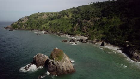 rocky coastline with cliffs and waves crashing on the shore