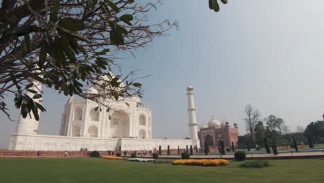 reveal from the heavenly charbagh garden leading up to the noble taj mahal - wide reveal dolly shot