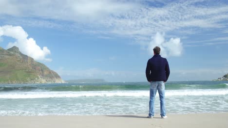 mature man standing on the beach