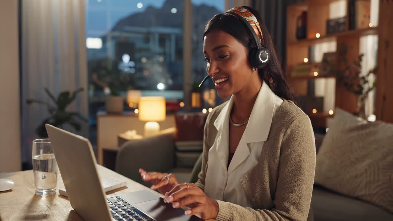 Woman working from home on laptop with headset