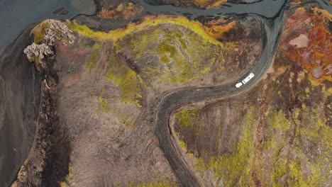 Bird's-eye-view-over-transport-van-driving-through-dramatic-Iceland-landscape