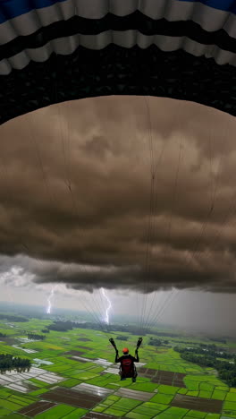 paragliding in a storm over rice paddies