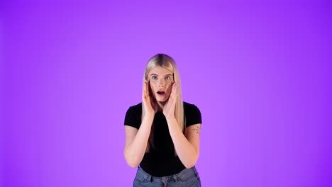 portrait of young blonde woman astonished, astonishment gesture and expression, studio shot with purple background