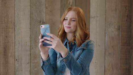 young stylish red head portrait of beautiful woman smiling posing taking selfie photo using smartphone camera technology wearing stylish denim jacket