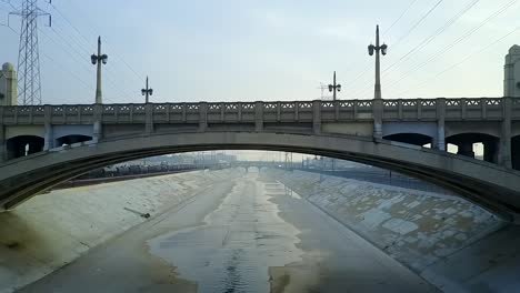 push in under downtown la river arch bridge viaduct urban storm sewer flood control, aerial