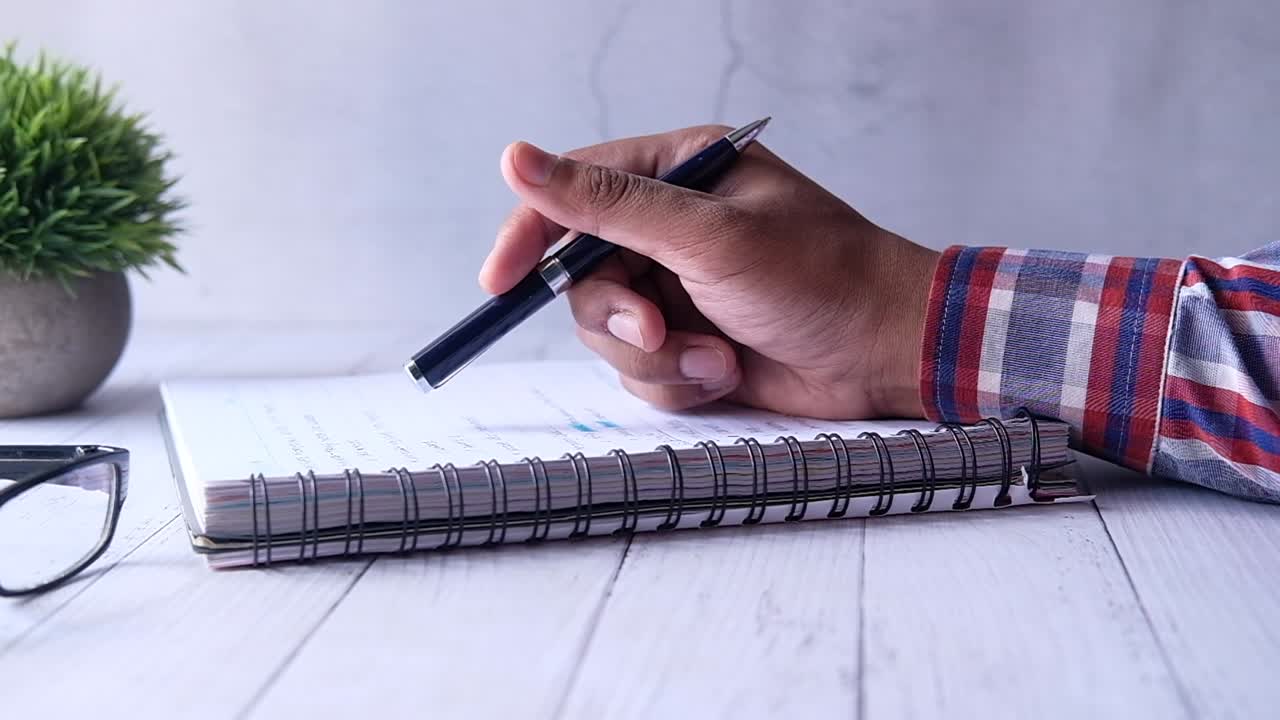 Person writing in a notebook