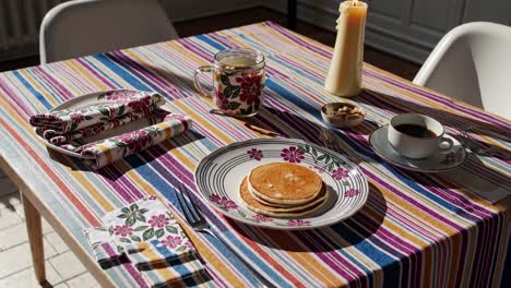 breakfast table setting with pancakes and coffee